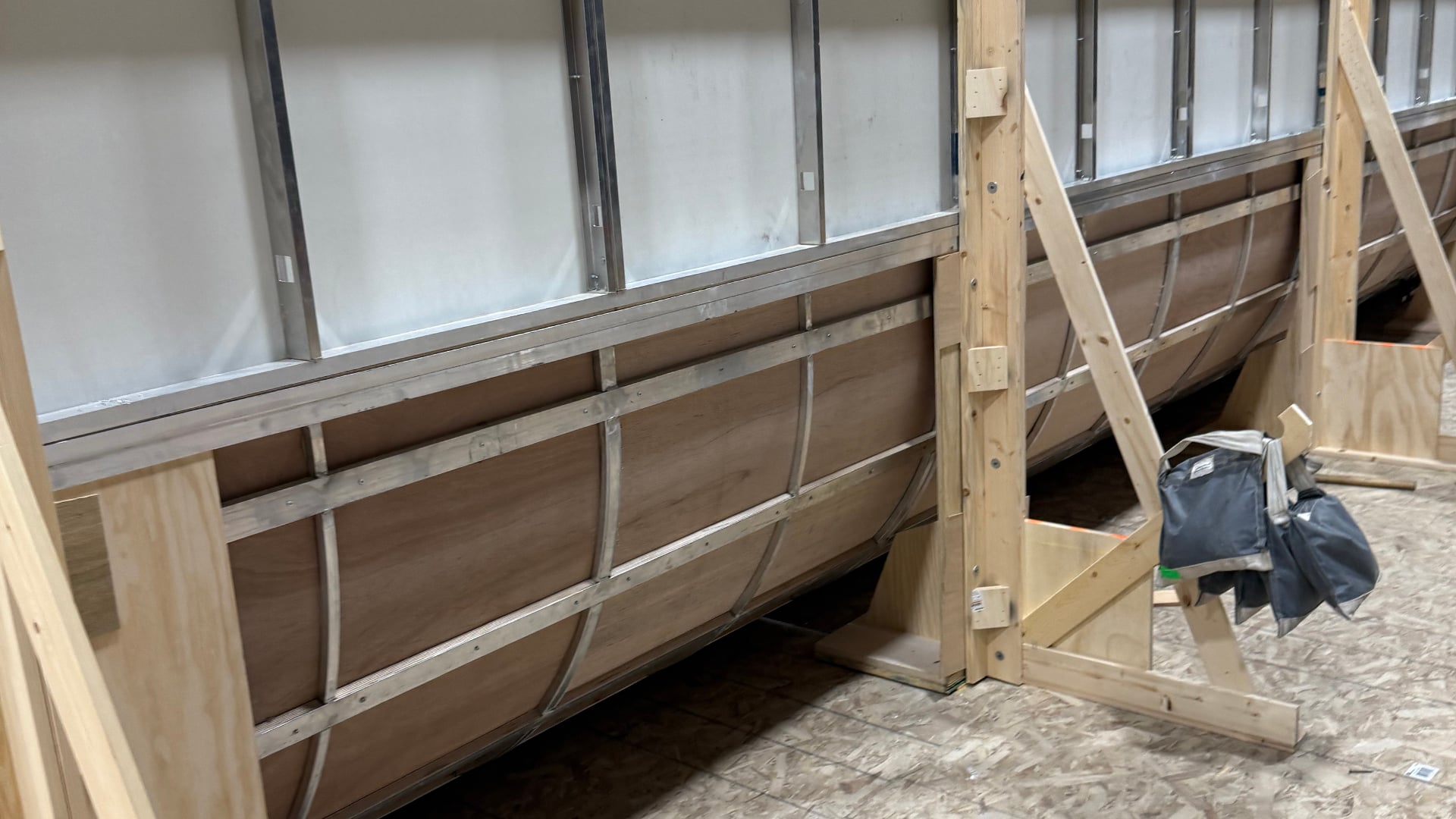 Curved cove wall panels with wooden framework and support braces on soundstage