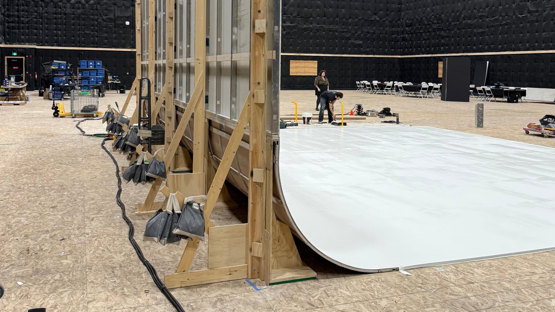 Curved cove wall panels with wooden framework and support braces on soundstage