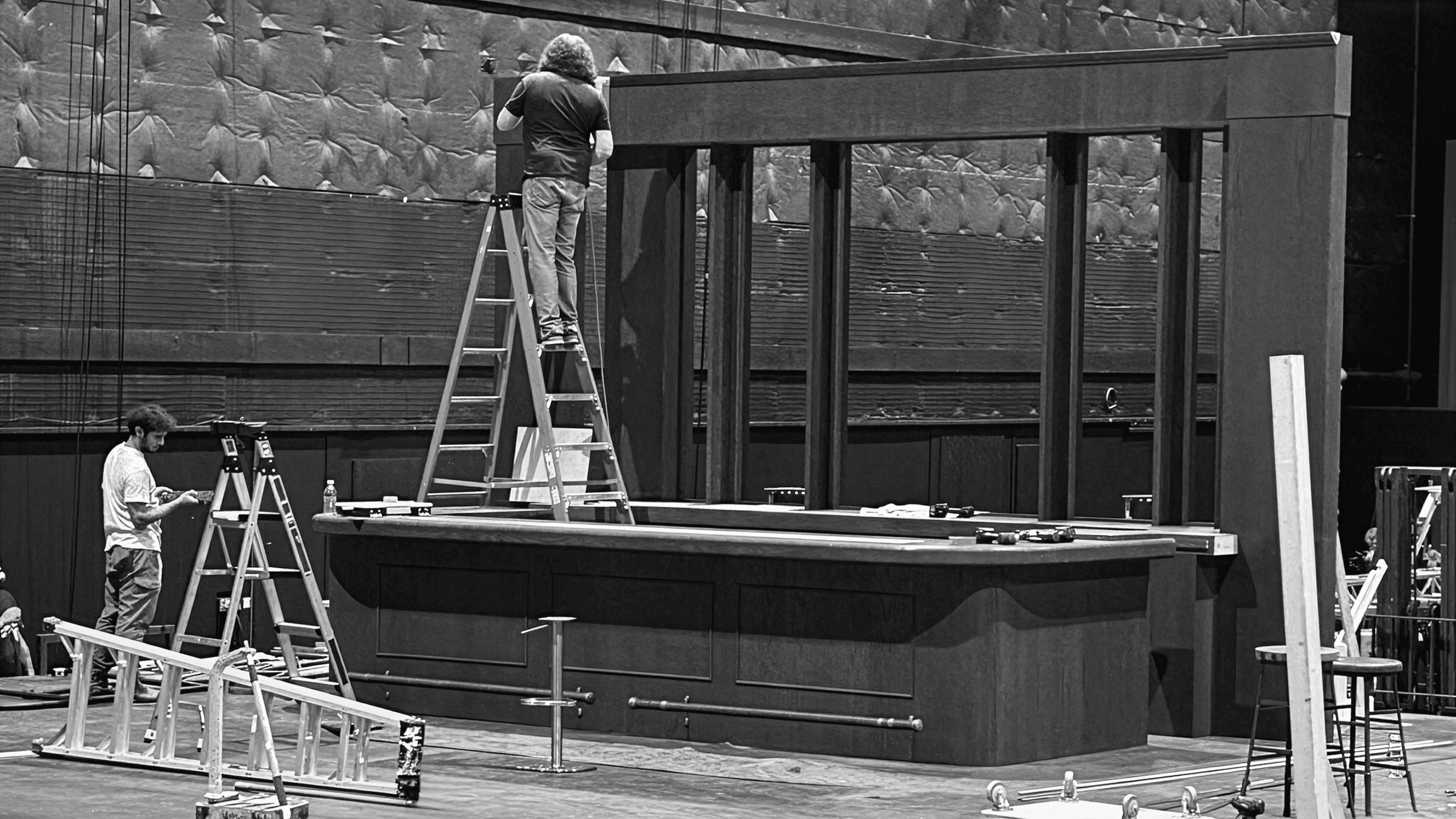 Crew constructing a wooden bar set on a soundstage for Captain Morgan commercial