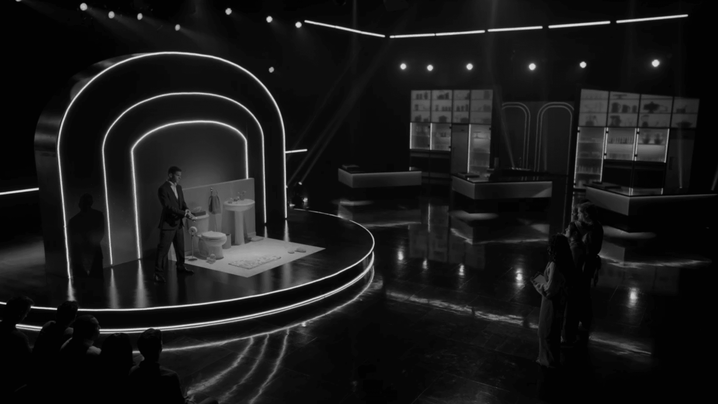 Main stage reveal moment on Is It Cake set with host and contestant under neon arch lighting