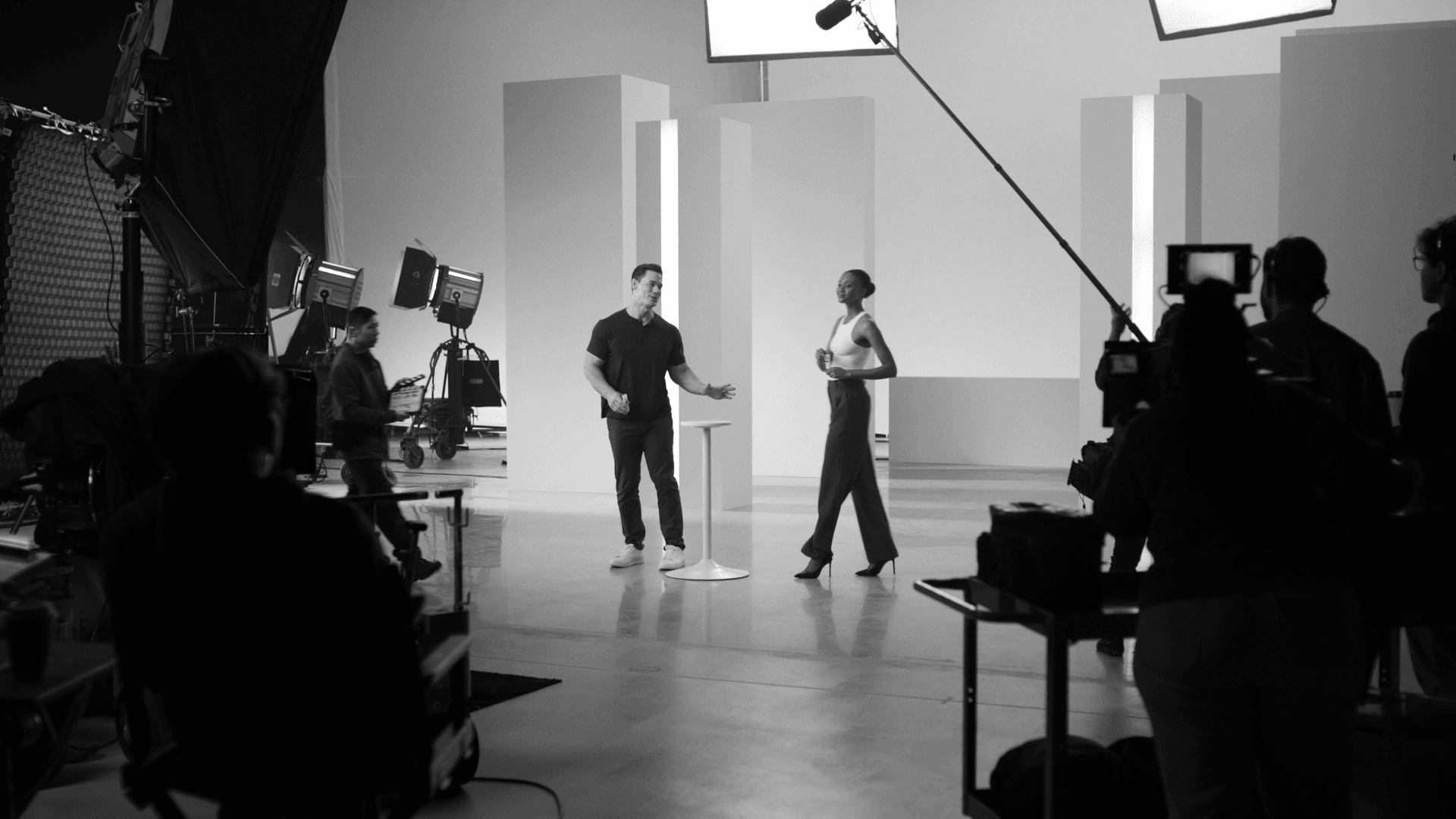 Two actors on a minimal white studio set with modular wall panels during Neutrogena commercial shoot