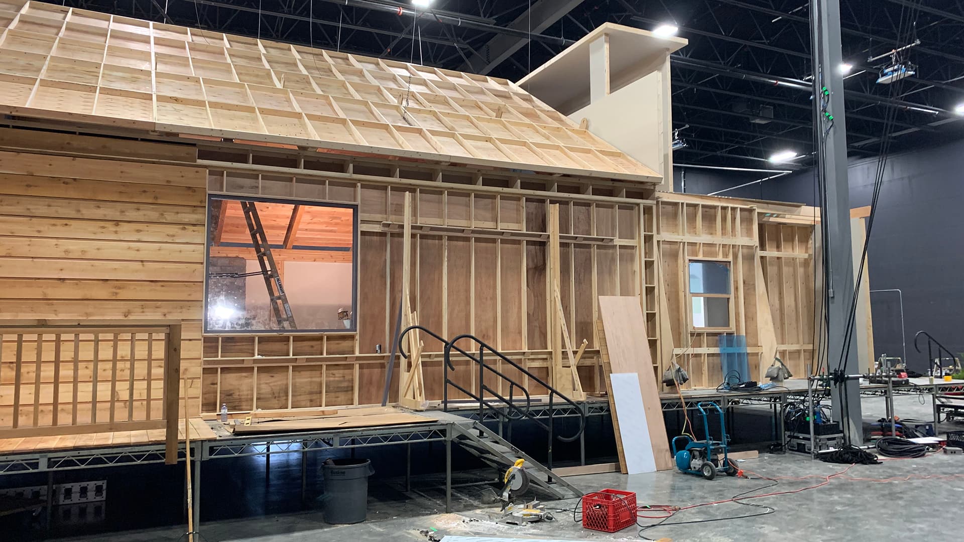 Rear view of cabin set showing roof framing and wall construction in warehouse for Pepsi commercial