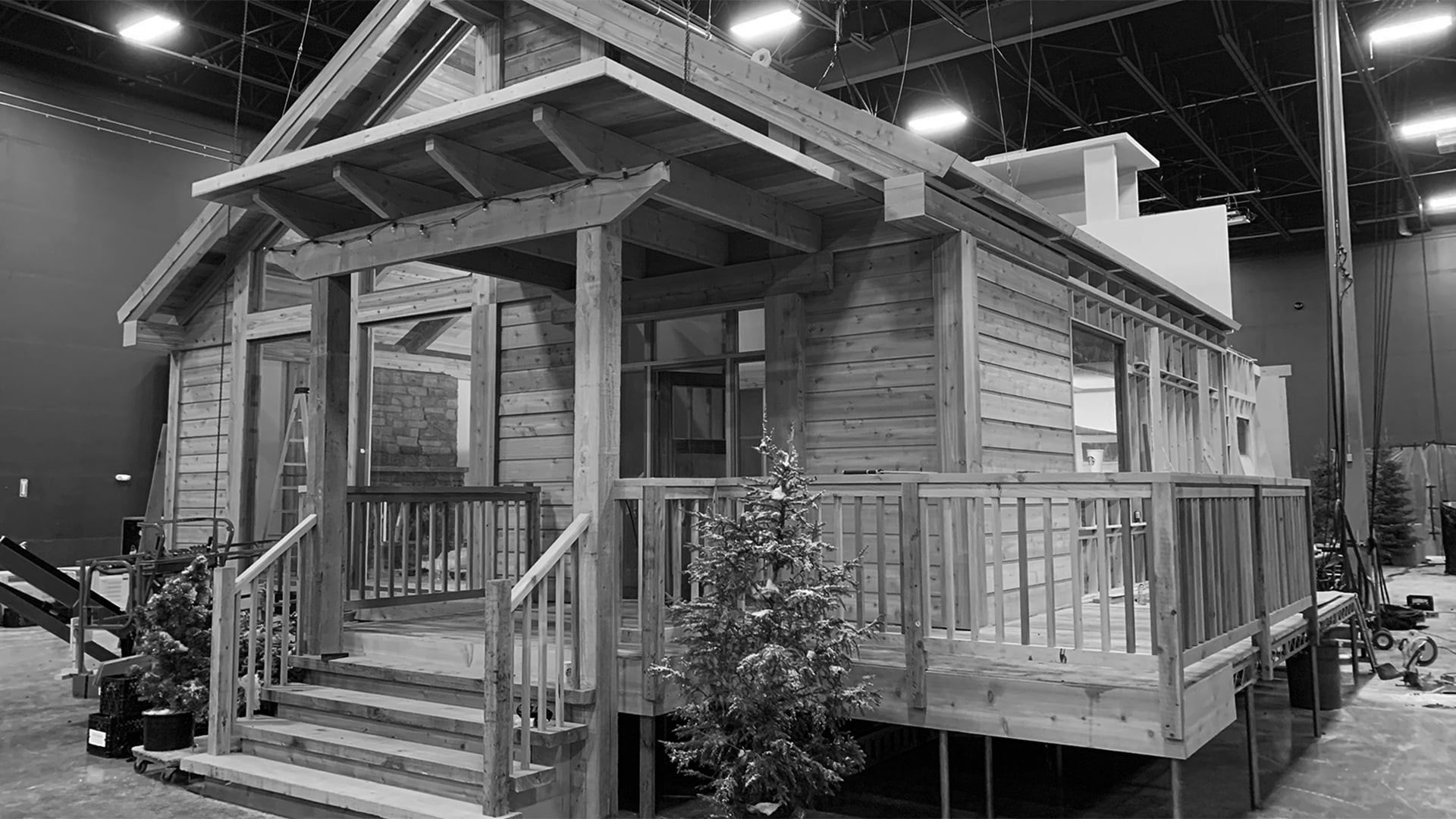 Rear view of cabin set showing roof framing and wall construction in warehouse for Pepsi commercial